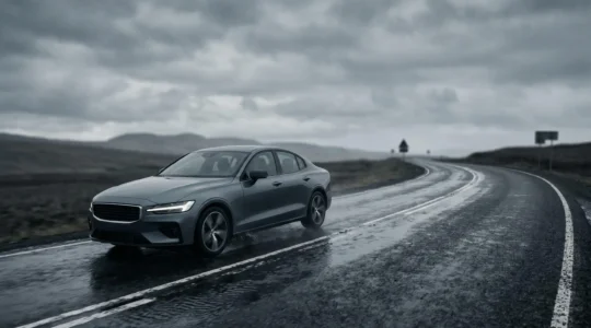 Vehicle maintaining controlled trajectory on wet road surface demonstrating electronic stability control intervention during emergency maneuver