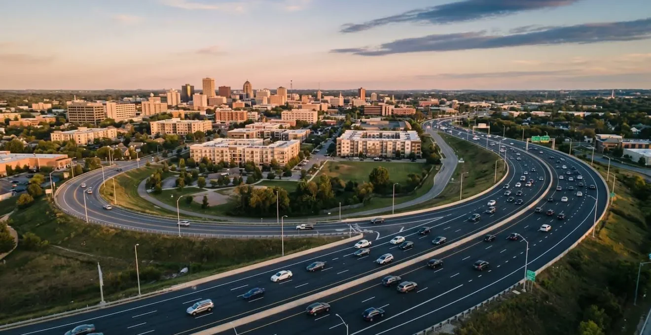 Aerial view of modern ring road bypass system with flowing traffic during golden hour, highlighting efficient traffic management and stress-free commuting